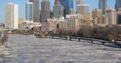 Photo of the frozen Schuylkill River, with the city of Philadelphia in the background. (Polar Vortex)