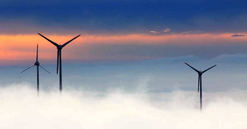 Image of wind turbines surrounded by clouds: clean energy | Climate Nexus Polls