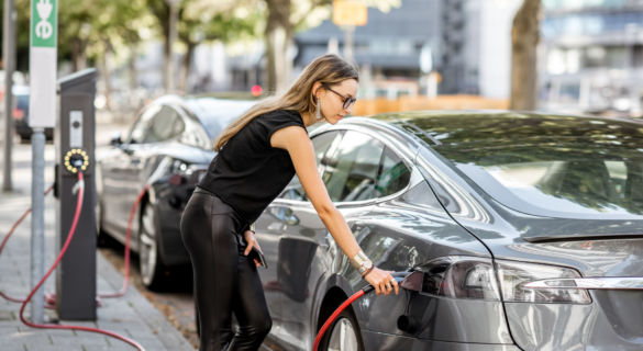 Woman charing electric cars connected to power grid