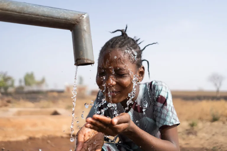 Girls Drinking_water_from_pipe | Climate Nexus Polling