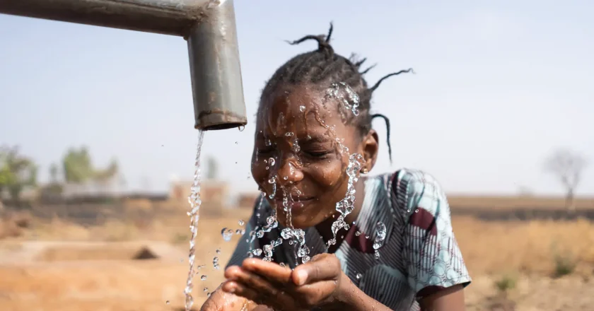 Girls Drinking_water_from_pipe | Climate Nexus Polling